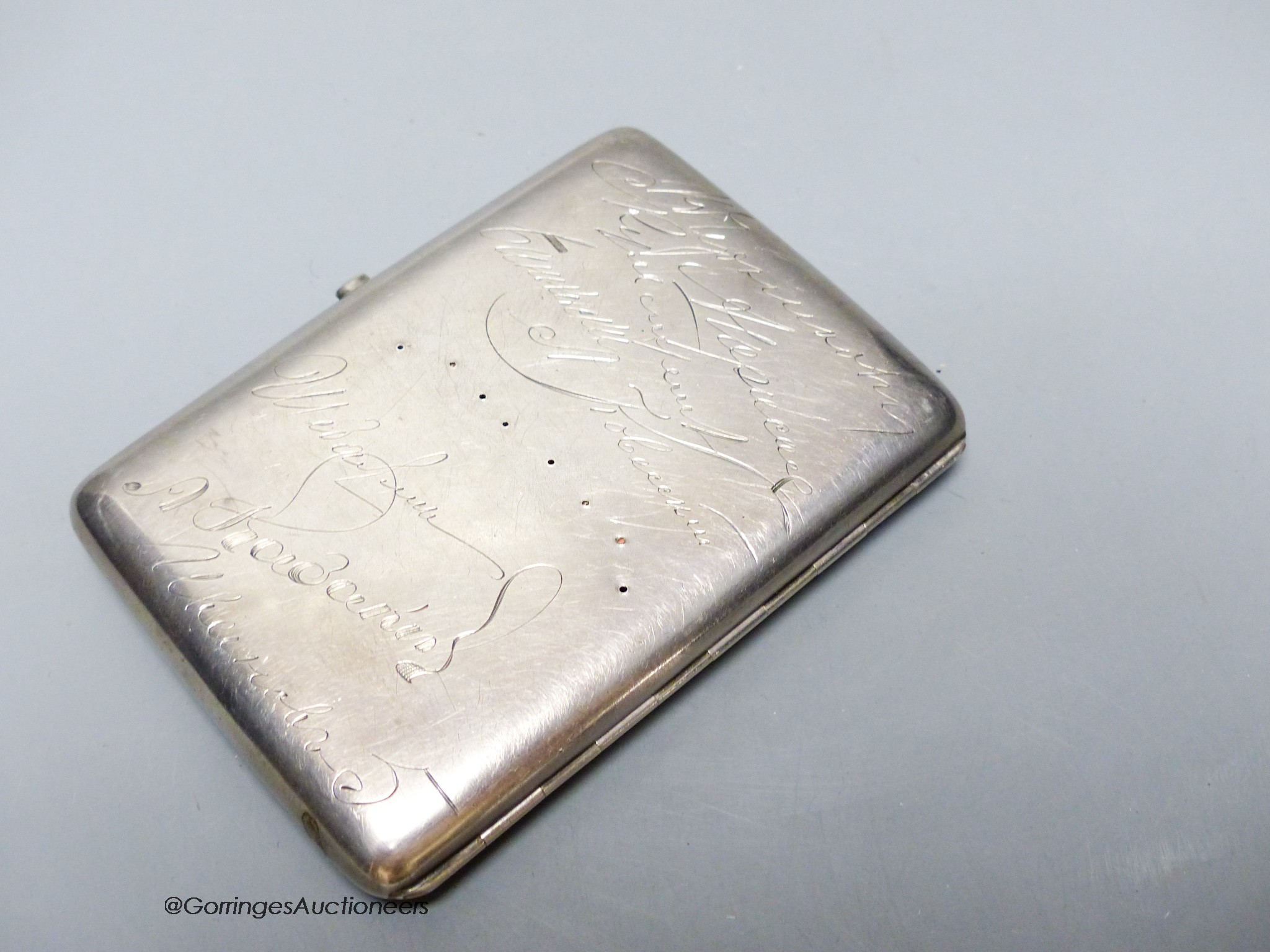 An early 20th century Russian 84 zolotnik cigarette case, presented to V.P. Nikolaev (in command of the Russian port of Kronstadt) and engraved with the signatures of colleagues, 11.4cm.